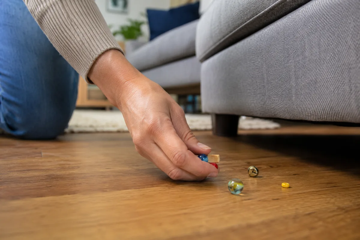Parent checking floor for small choking hazards