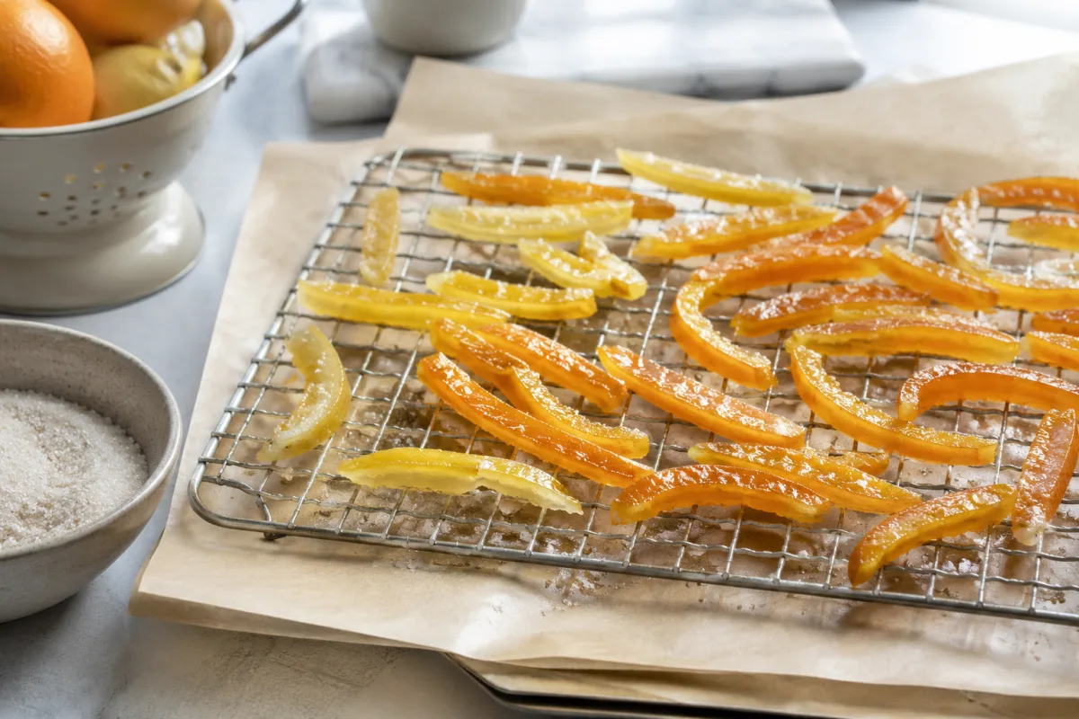 Candied orange and lemon peel drying on a wire rack