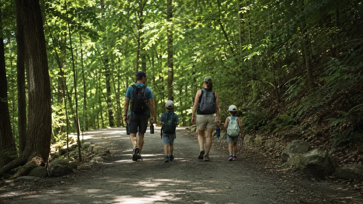 Family walking together on a shaded trail
