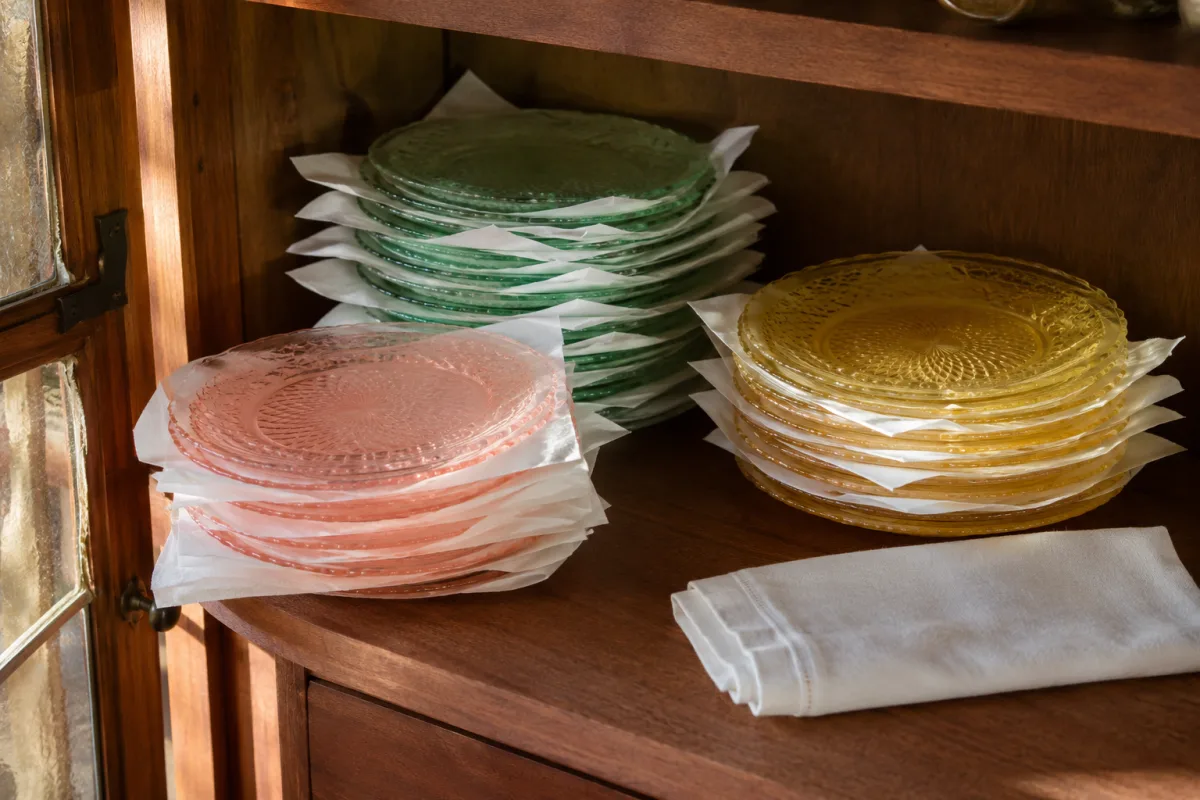 Stacked Depression glass plates separated by soft archival tissue in a cabinet
