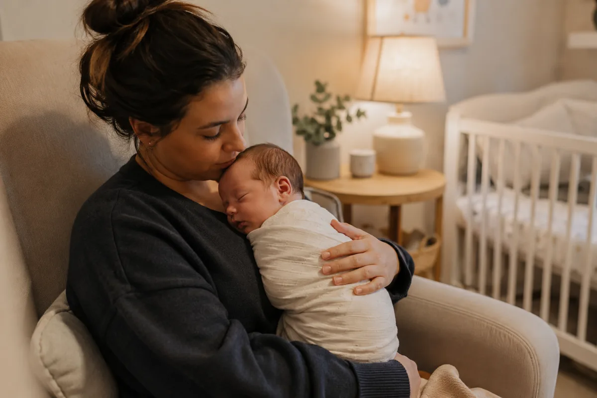 Newborn held upright after feeding