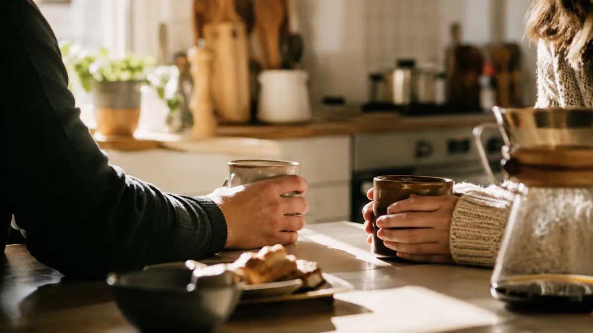 Married couple sharing a quiet kitchen joke