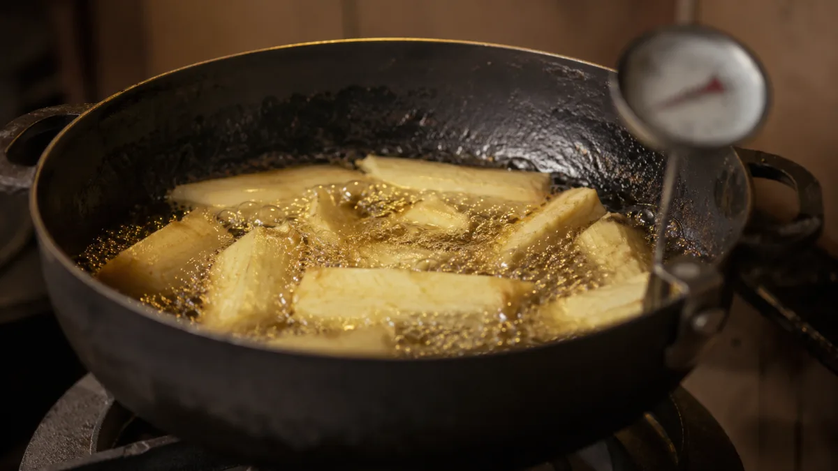 African yam frying in heavy pot