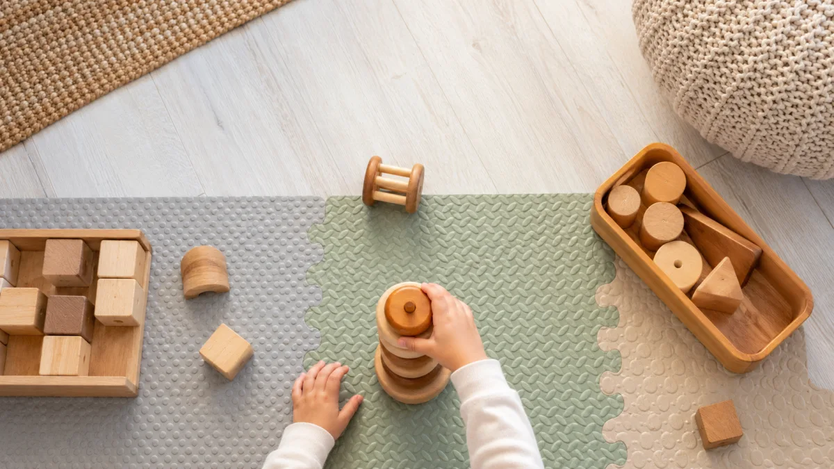 Occupational therapist working with a toddler on a play mat during an early intervention session