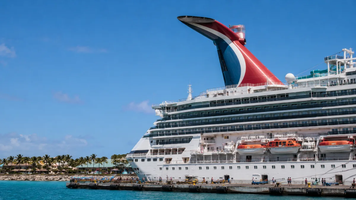 Carnival cruise ship whale tail funnel photographed from the dock at a Caribbean port