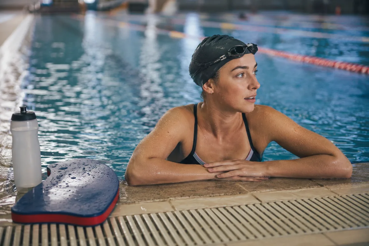 Beginner swimmer resting at pool edge