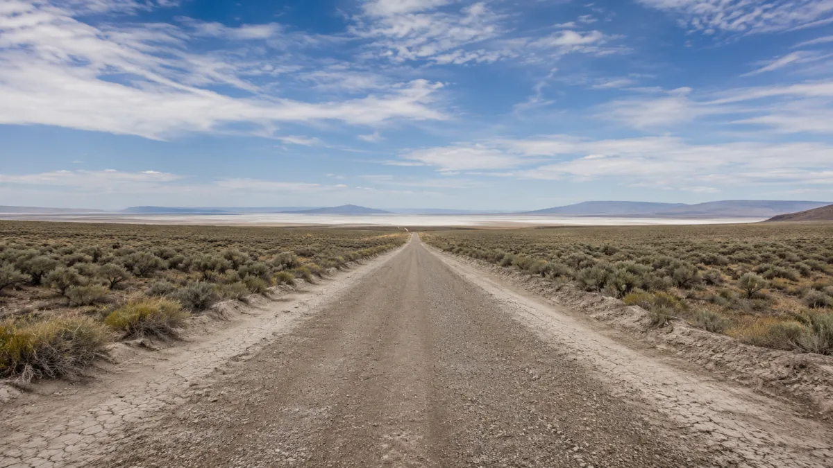 Unpaved gravel road through the Utah desert leading toward Rozel Point and the Spiral Jetty