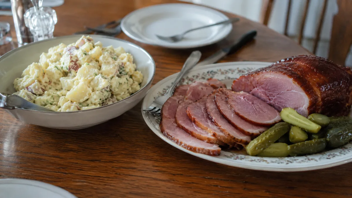 Potato salad served with sliced ham