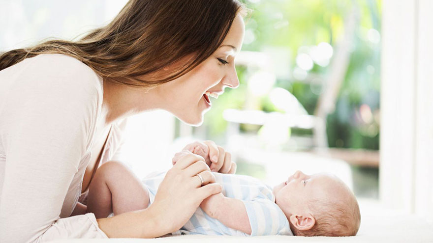 Read and talk to your newborn often to stimulate her sense of hearing
